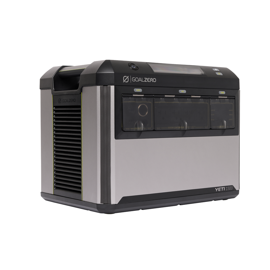 Goal Zero Yeti 1500 portable power station, angled view showing the moulded top carry handle, the power button and status display on the top face, three tinted port bays across the front labelled for 12 V, AC and USB output, and a louvred ventilation panel on the side of the silver and black body.